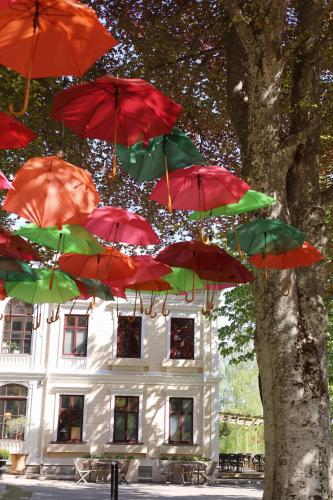 a bunch of red umbrellas in front of a building at Karstorp Säteri – Hotell och Konferens in Skövde