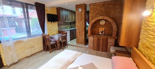 a kitchen with a table and a brick oven at Apartments Lukić in Soko Banja