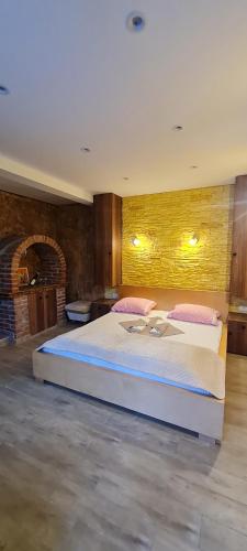 a large bedroom with a large bed with pink pillows at Apartments Lukić in Soko Banja