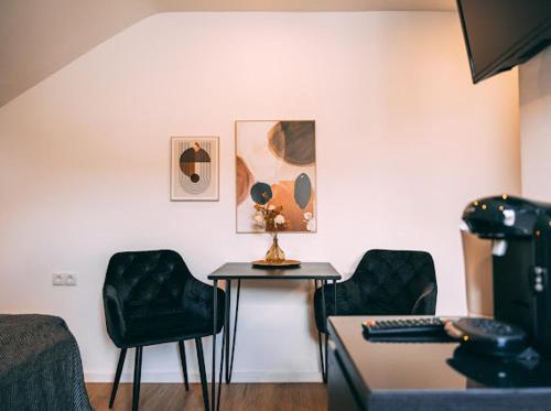 a room with a table and two chairs and a table with a tableablish at Premium Apartments Koblenz in Koblenz