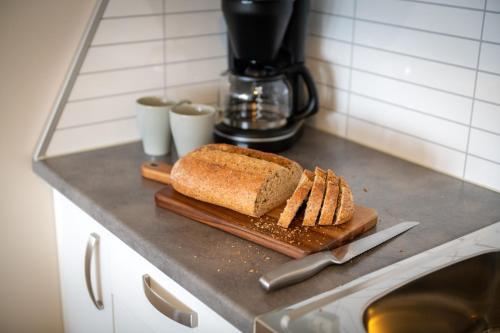 a loaf of bread on a cutting board on a counter at Hotell Regine in Bø