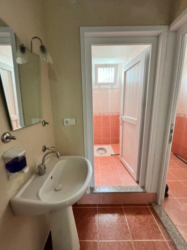 La salle de bains est pourvue d'un lavabo et d'une douche. dans l'établissement Gunguli Pansiyon, à Kukunat