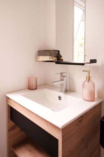 a bathroom with a white sink and a mirror at L'Orée de l'Océan - Vendée in Landevieille