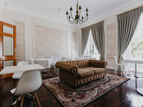 a living room with a couch and a table and chairs at Akamah Estate in Cape Town