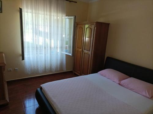 a bedroom with a bed and a large window at Apartments Krivokapic in Bijela