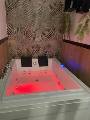 a bath tub with red light in a bathroom at RESIDENCE GORDON in Carini