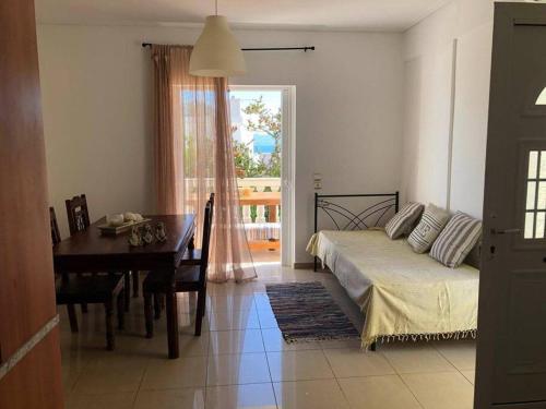 a bedroom with a bed and a table and a dining room at Nikolas house in Megalochori