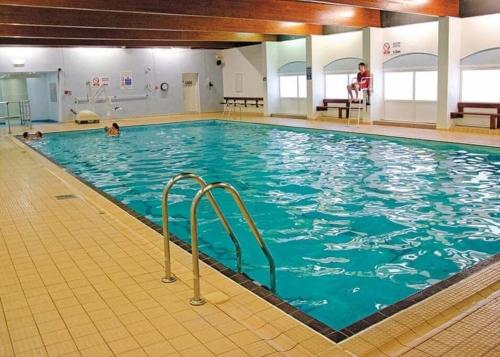 a large indoor swimming pool with blue water at 6 berth holiday home on Ocean Edge near Morecambe in Heysham
