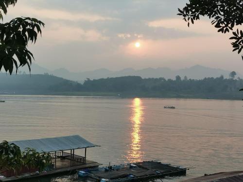 a view of a river with a boat in the water at Baan Dongsak River view in Sangkhla Buri