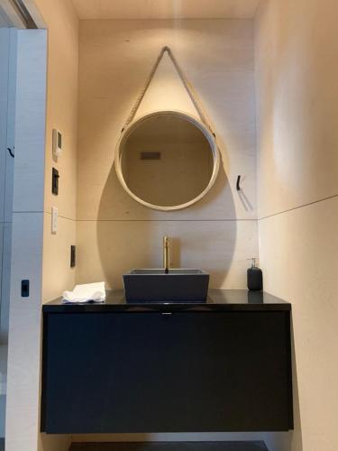 a bathroom with a sink and a mirror at Cabine A in Petite-Rivière-Saint-François