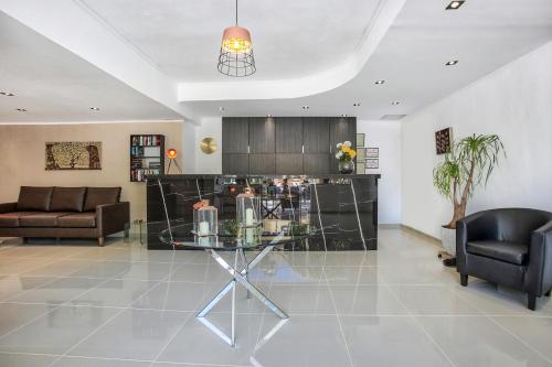 a living room with a glass table and two chairs at Happy Days in Malia