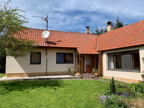 a house with an orange roof and a yard at Chalupa Lužnice in Třeboň