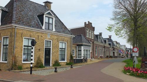 a row of brick houses on a street at B&B Ferdivedaasje in Dokkum