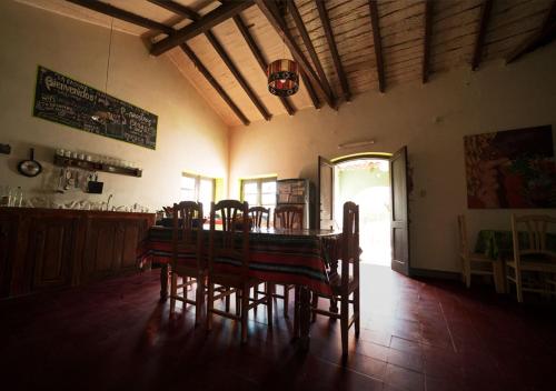 a dining room with a table and chairs in a room at Familia Albahaca in Tilcara