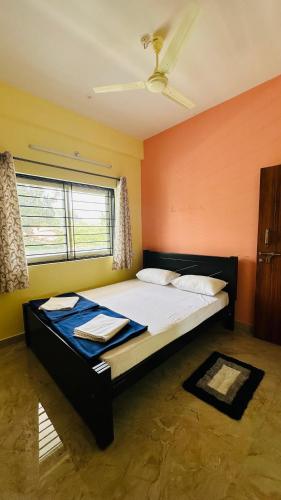 a bedroom with a large bed in a room at Navile Apartments in Chikmagalūr