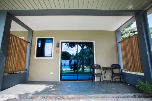 an open door to a patio with a table and chairs at Hidden Lagoon Resort in Panglao