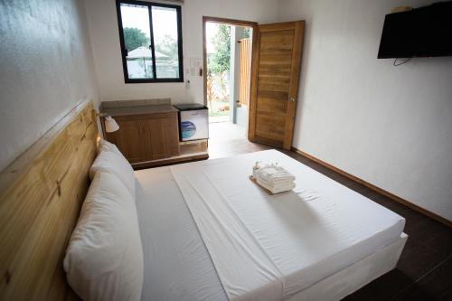a bedroom with a large white bed in a room at Hidden Lagoon Resort in Panglao