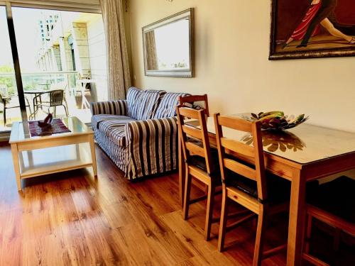 a living room with a table and a couch at Nomi Suites Marina Herzelia in Herzelia 