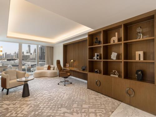 a living room with a couch a chair and a table at Kempinski The Boulevard Dubai in Dubai
