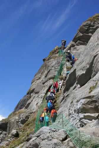 a group of people climbing up the side of a mountain at Wellness- und Schneesporthotel Christiania in Saas-Almagell