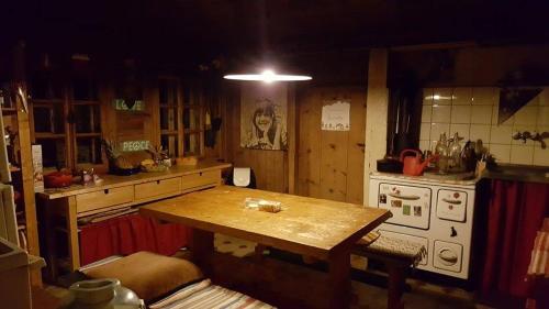 a kitchen with a table and a stove at L'Étoile Enchantée in Ciernes-Picat