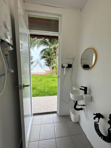 a bathroom with a sink and a mirror at Beach N Breeze Glamping in Melaka