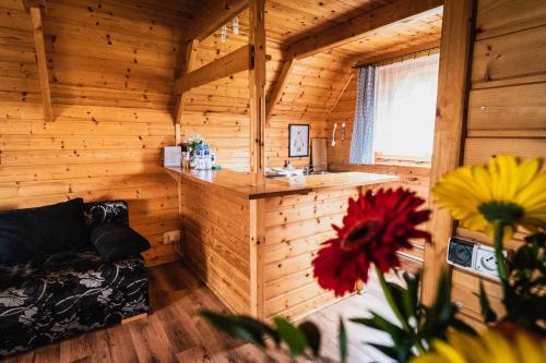 Cabaña de madera con sofá en una habitación en Domki Bałtyckie, en Władysławowo