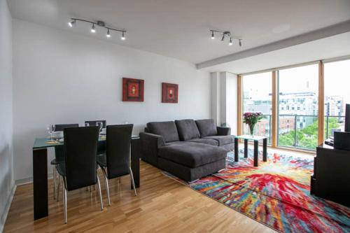a living room with a couch and a table at Grand Canal Square Apartments in Dublin