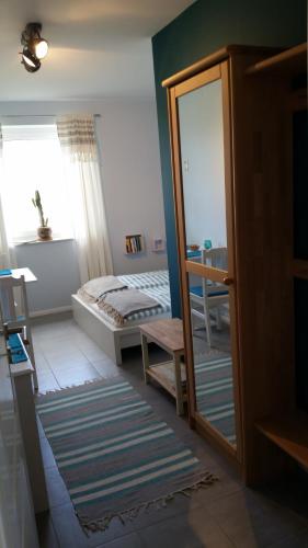 a bedroom with a bed and a mirror at BED & BREAKFAST für Individualisten in Gemeinde Scharbeutz, auch Allergiker in Scharbeutz