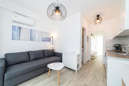 a living room with a couch and a table at Nefeli & Nefeli Luxury Residential Complexes in Ofrínion