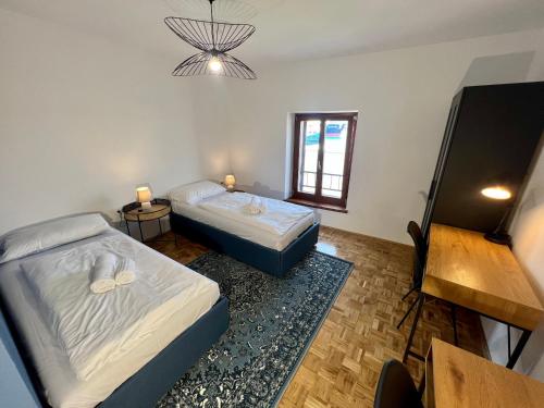 a bedroom with two beds and a chandelier at Libertas apartments in Koper