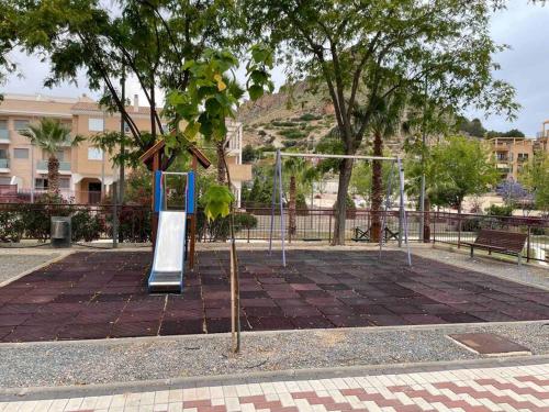 a playground in a park with a swing set at NATUR Spa in Villanueva de Río Segura