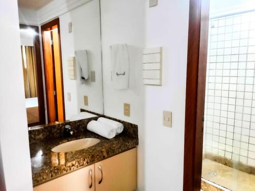 a bathroom with a sink and a mirror at Flat Hotel Mercure - Centro de Brasília A012 in Brasilia