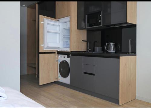 a small kitchen with a washing machine and a washer at Bukovel Village Apartments in Bukovel