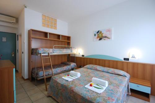 a hotel room with two beds and a ladder at Hotel Sporting in Alba Adriatica
