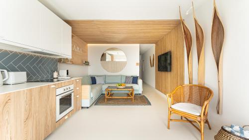 a kitchen and living room with a couch and a table at ZAMA Apartment in Acantilado de los Gigantes