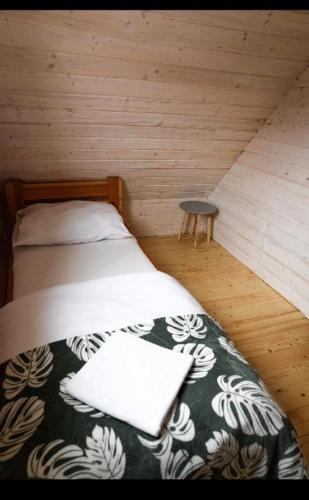 a bedroom with a bed in a wooden room at Domki u Tutki in Szklarska Poręba