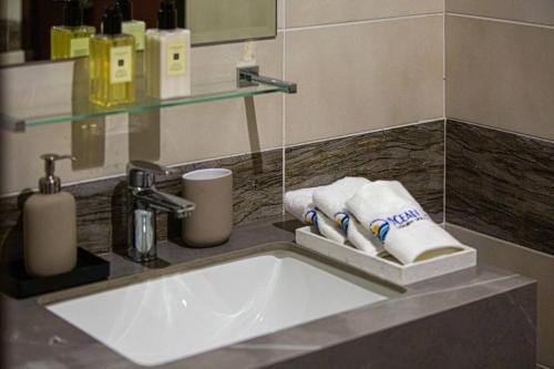 a bathroom sink with towels and a faucet at Luxury Seaview 7 Bedrooms Villa in Fujairah