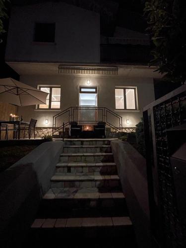 a staircase leading to a house at night at La Mirage in Desenzano del Garda