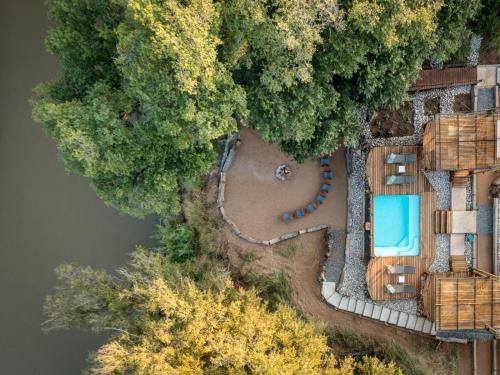 an aerial view of a resort with a swimming pool and trees at Hideaways Amava River Lodge, Balule, Greater Kruger in Hoedspruit