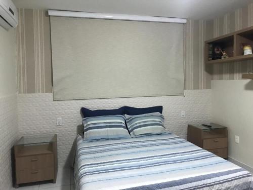 a bedroom with a bed with a large window at Excelente casa 300m2 em Bairro Nobre perto de tudo in Natal