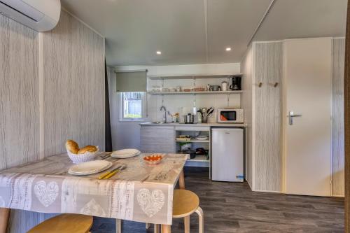 a kitchen with a table with plates on it at Camping Eden Glamping in Dormelletto