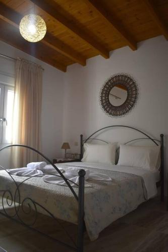 a bedroom with a bed and a mirror on the wall at Garden House - Kastri Crete in Kastrí
