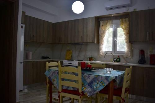 a kitchen with a table and chairs and a sink at Garden House - Kastri Crete in Kastrí