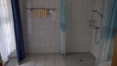 a bathroom with a shower with a shower curtain at CAREA Hotel Fürstenhof in Haigerloch