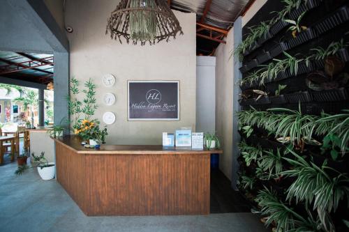 a reception desk in a room with plants at Hidden Lagoon Resort in Panglao