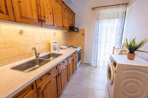 a kitchen with a sink and a washing machine at La Casa Di Volpe in Corfu Town