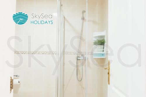 a shower with a glass door in a bathroom at Sky Sea Holidays MIJAS COSTA in La Cala de Mijas