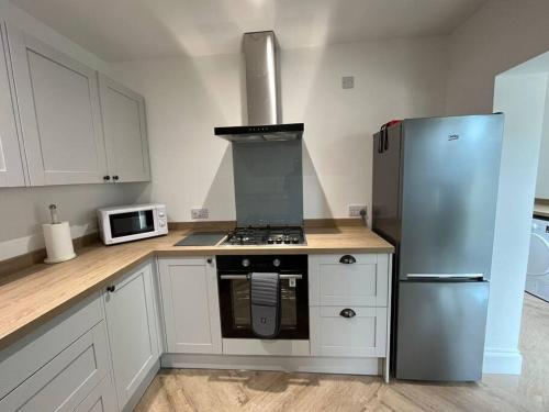 a kitchen with a stove and a refrigerator at Beach retreat! in Pakefield