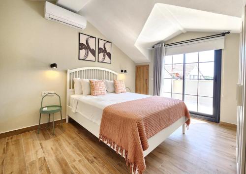 a bedroom with a bed and a large window at Guney Suites by Villa Safiya in Göcek
